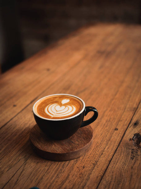 coffee latte on the wood desk in cafe - Фото, зображення