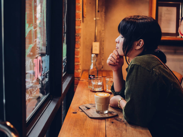 Asian woman drinking coffee in  coffee shop cafe   - Foto, imagen