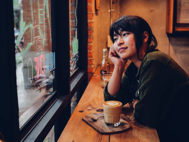 Asian woman drinking coffee in  coffee shop cafe   - Photo, image