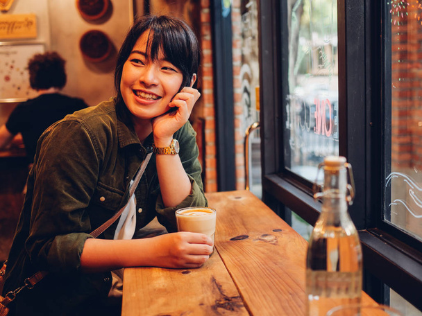 Asian woman drinking coffee in  coffee shop cafe   - Foto, Imagen
