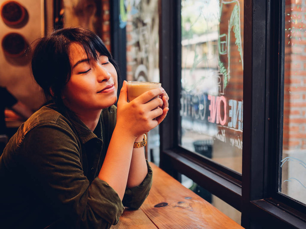 Asian woman drinking coffee in  coffee shop cafe   - Photo, image