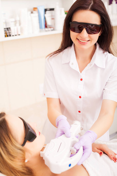 Skin care. Adult woman having laser hair removal in professional beauty salon - Фото, зображення