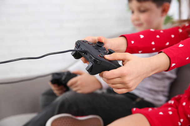 Children playing video game at home, closeup - Foto, Imagem