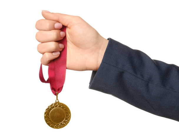 Woman holding golden medal on white background, closeup - Foto, afbeelding