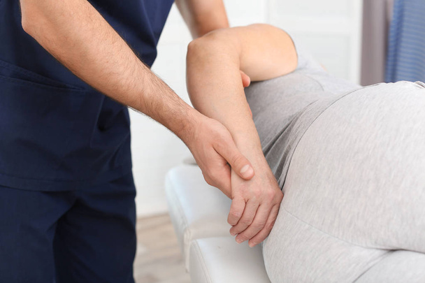 Physiotherapist working with patient in clinic, closeup. Rehabilitation therapy - Foto, imagen