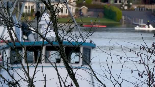 kayaks paddle by behind group of boats docks and trees - Footage, Video