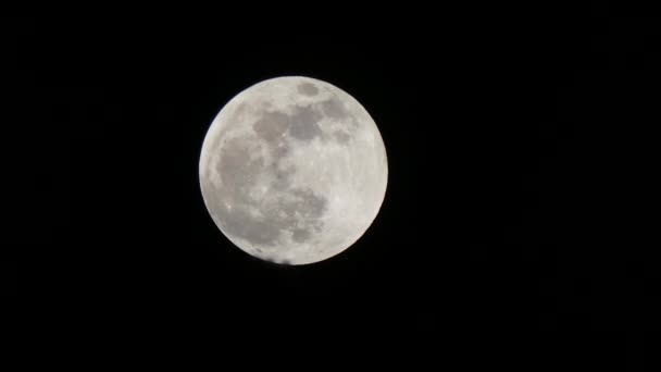 bit of eclipse showing on super moon in dark sky - Footage, Video