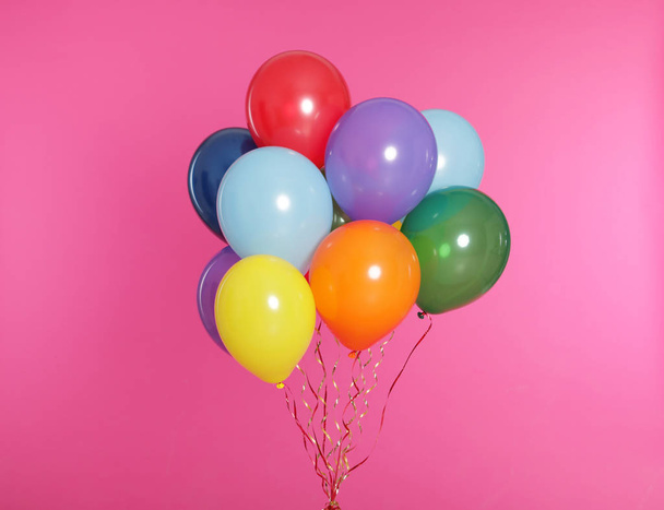 Bunch of bright balloons on color background - Φωτογραφία, εικόνα