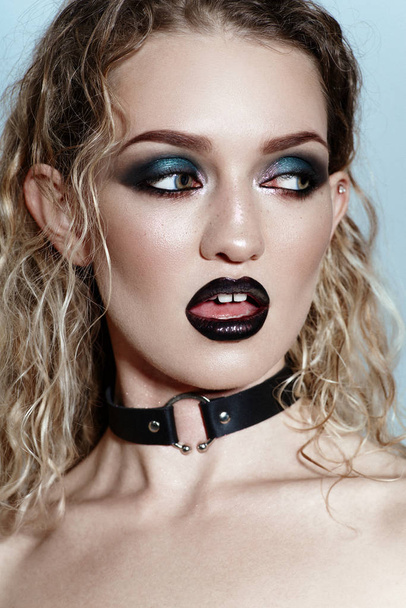 portrait of attractive blonde woman with dark gothic makeup in leather choker  - 写真・画像
