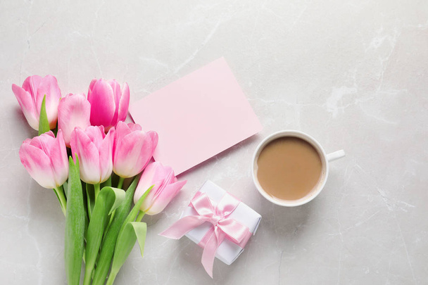 Flat lay composition of tulips and blank card on marble background, space for text. International Women's Day - Фото, зображення