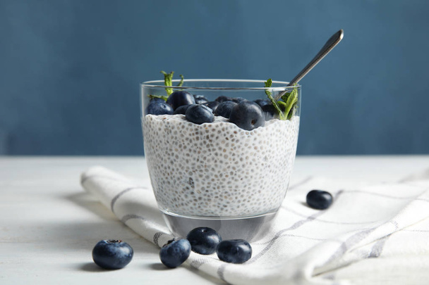 Tasty chia seed pudding with blueberries in glass on table - Zdjęcie, obraz