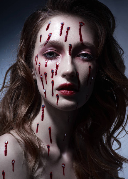 portrait of beautiful woman with bright make-up and bleeding stars on face, close-up  - Foto, immagini