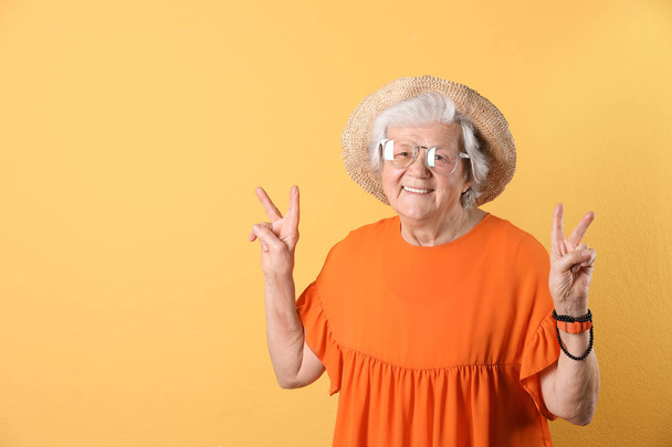 Portrait of cool grandmother on color background, space for text - Foto, Imagen