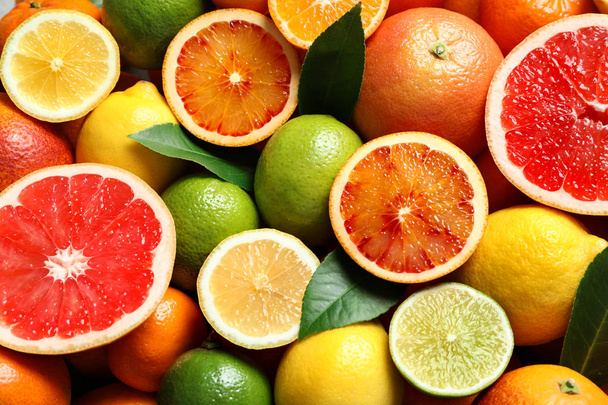 Different citrus fruits as background, top view - Photo, Image