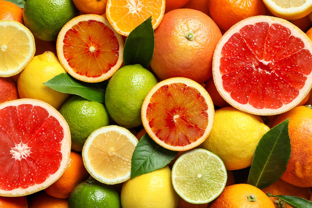 Different citrus fruits as background, top view - Фото, зображення