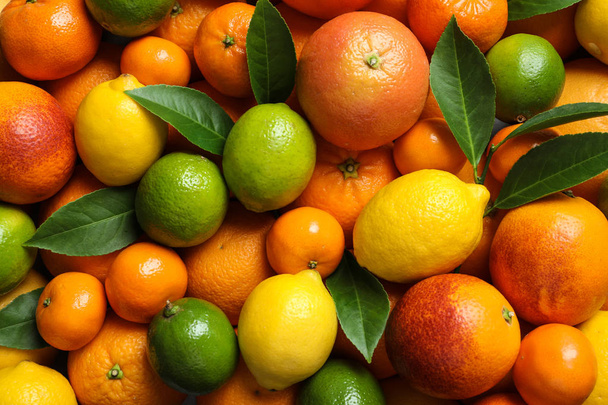 Different citrus fruits as background, top view - Foto, immagini