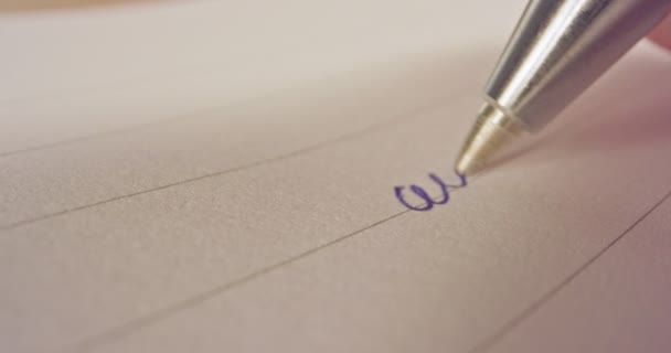 Macro instantâneo de uma ponta de caneta escrevendo palavras francesas no papel
 - Filmagem, Vídeo