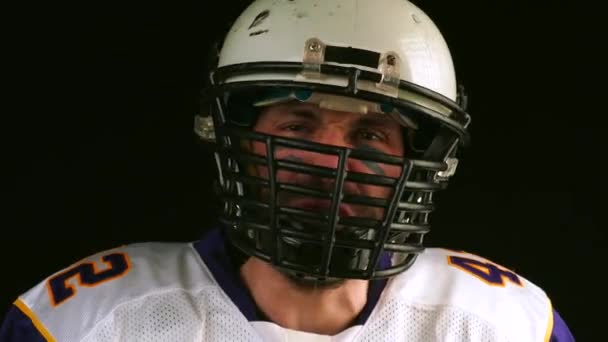 American football. american football player emotionally speaks into camera. many emotions. close-up. Black background - Footage, Video