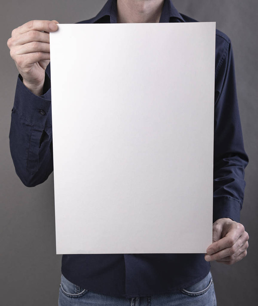 A man holding white poster - Photo, Image