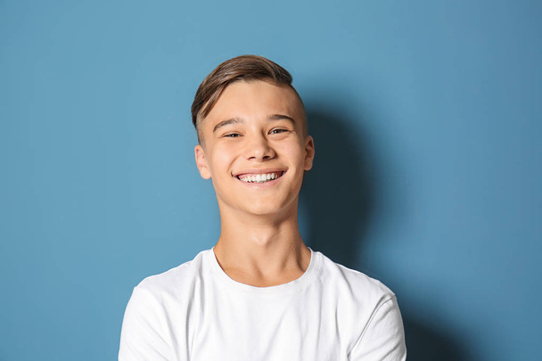 Smiling teenage boy on color background - Photo, Image