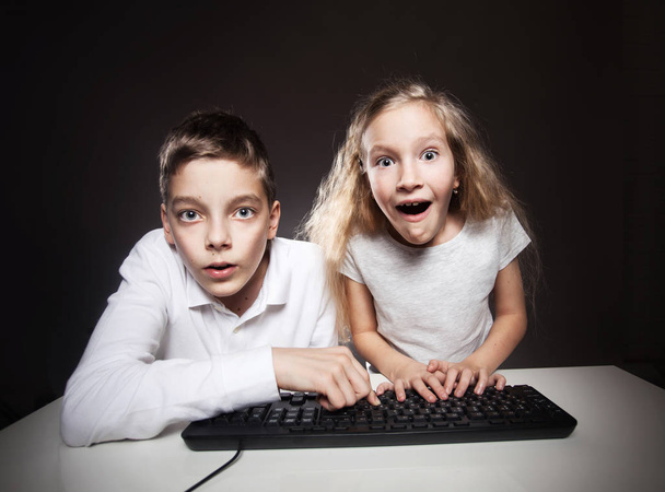 Surprised child looking at a computer - Fotó, kép
