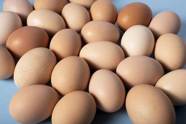 Brown eggs on blue background - Photo, Image