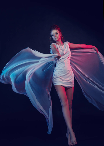 Fashion portrait of young elegant girl in white dress. Black background, studio shot. - Foto, Imagem