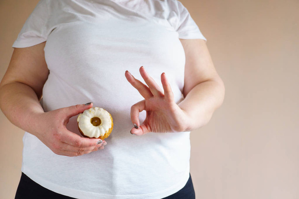 overweight woman with OK gesture and sweet donut - Photo, Image
