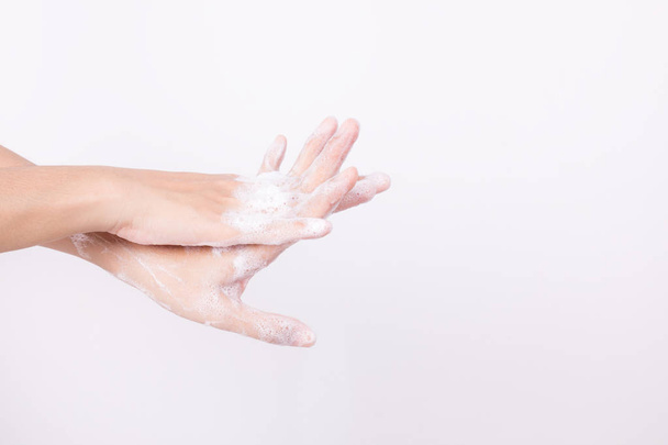 Asian woman hand are washing with soap bubbles on white background - Fotografie, Obrázek