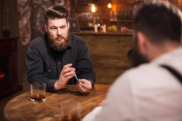 Retrato de hombre barbudo guapo barajando cartas de juego en un pub
 - Foto, imagen