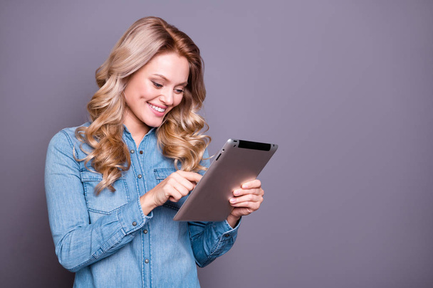 Portrait of her she nice cute lovely charming attractive cheerful cheery wavy-haired lady wearing blue shirt holding in hands new cool tablet isolated over gray pastel background - Φωτογραφία, εικόνα