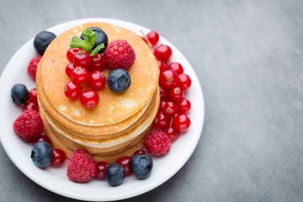 Stack of pancakes with blueberry and fresh berry. - Photo, Image