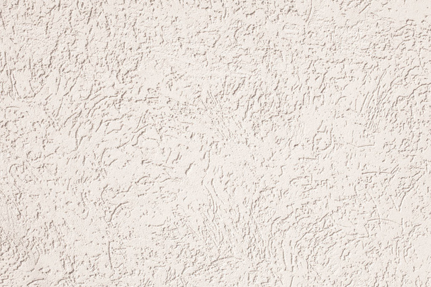 Photo of the concrete wall of the house with rubbing. Sunny day. Texture background - Photo, Image