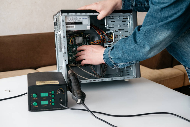 Repairman is disassembling personal computer. Engineer is diagnostic and fixing broken pc in workshop. Electronic repair shop, technology renovation, business, occupation concept - Фото, изображение