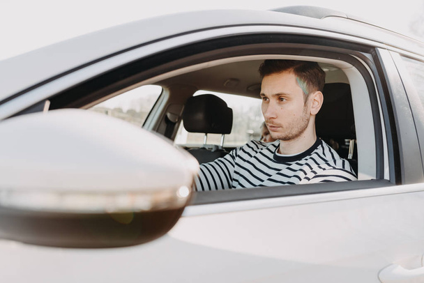 Attractive man driving white car  - Zdjęcie, obraz
