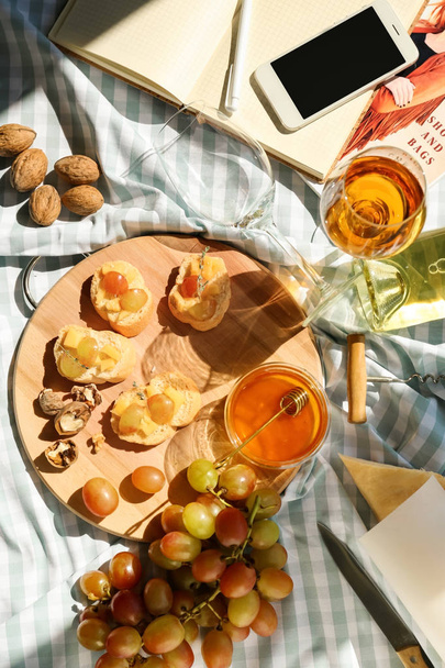 Tasty sandwiches with honey and wine on table - Photo, image