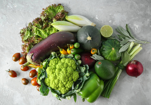 Various fresh vegetables on grey table - Foto, afbeelding