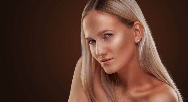 portrait of a girl. Golden shining makeup on the dark background - Photo, image