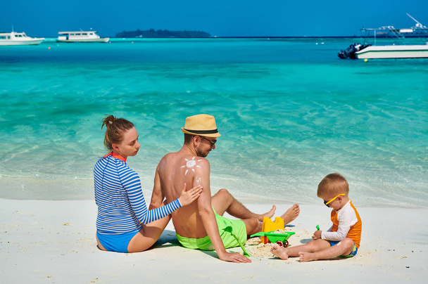 Familie mit dreijährigem Jungen am Strand - Foto, Bild