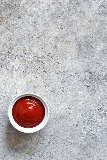Classic tomato sauce with spices on a concrete background.  - Fotoğraf, Görsel