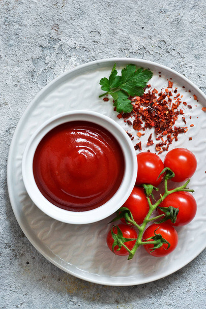 Classic tomato sauce with spices on a concrete background.  - Foto, Imagen