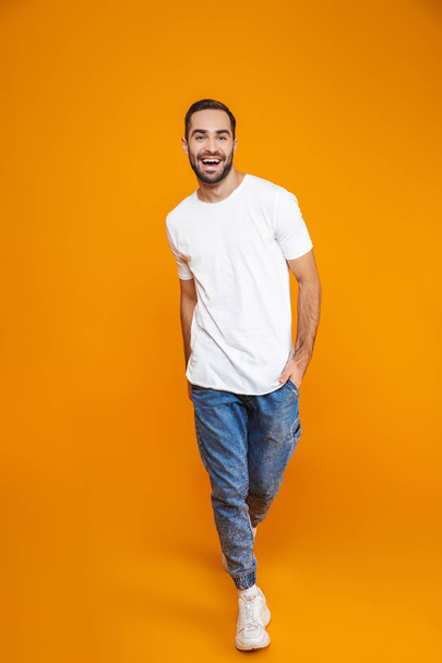Full length photo of adorable guy 30s in t-shirt and jeans smili - Foto, Imagem