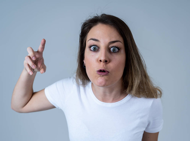 Close up portrait of young attractive caucasian woman with an angry face. Looking mad and crazy shouting and making furious gestures. Isolated on neutral background. Facial expressions and emotions. - Фото, зображення