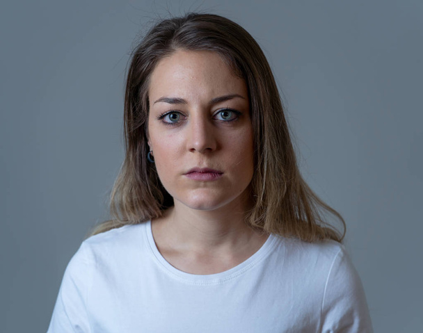 Close up portrait of beautiful young woman with sad mood looking miserable and melancholy. Human facial expressions and emotions, depression and mental health concept. Isolated on neutral background. - Fotografie, Obrázek