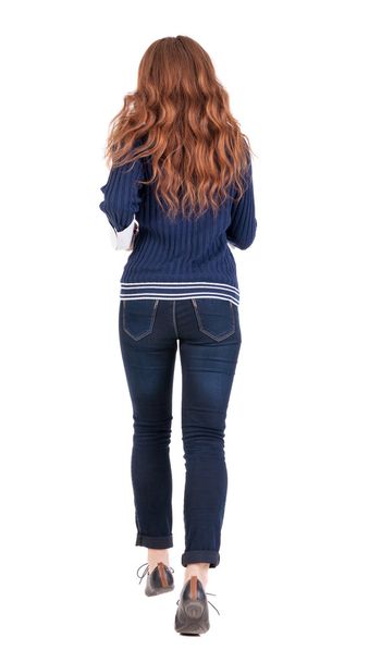 back view of running woman in jeans. - Фото, изображение