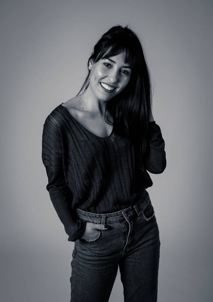 Black and white studio portrait of young beautiful caucasian woman with happy face and beautiful smile posing and modeling. In People, human expression and emotions, fashion and beauty concept. - Photo, Image