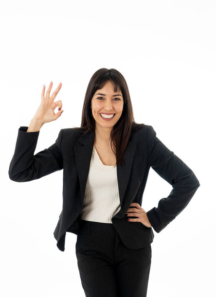 Half length portrait of young pretty business woman standing and making all OK gesture. Smiling feeling confident and successful. In people business education, success and work environment concept. - Foto, imagen