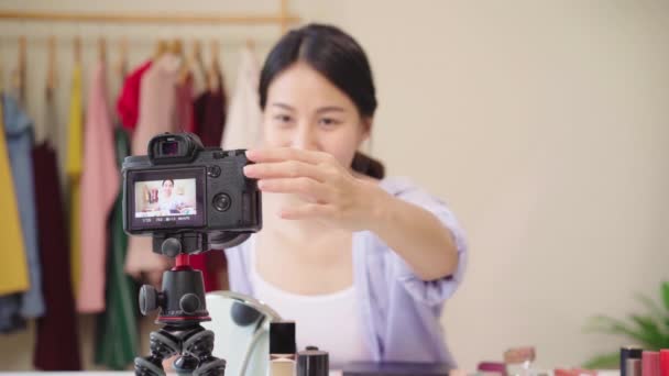 美容ブロガーは、ビデオ録画のためのカメラの前に座って美容化粧品を紹介します。幸せな美しい若いアジア女性使用化粧品レビューは、チュートリアルを構成するソーシャル ネットワークに放送します。. - 映像、動画