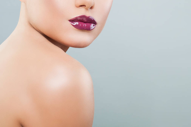 Beautiful woman lips with purple glossy lipstick and lipgloss - Foto, Imagem