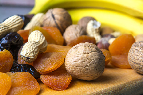 vegetariánské jídlo z ořechů a sušeného ovoce na kuchyňské desce - Fotografie, Obrázek